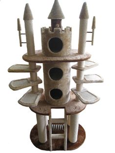 a cat tree with several cats in it's tower and one on the ground