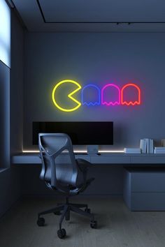 an office with a desk, chair and neon sign on the wall in front of it