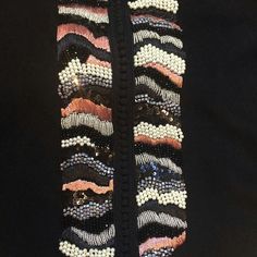 a close up of a jacket with beads on it