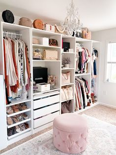 an organized closet with clothes, shoes and handbags on the shelves next to a chandelier