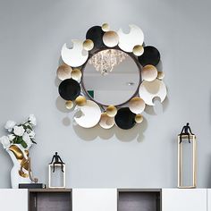 a mirror that is on the side of a wall next to some vases and lamps