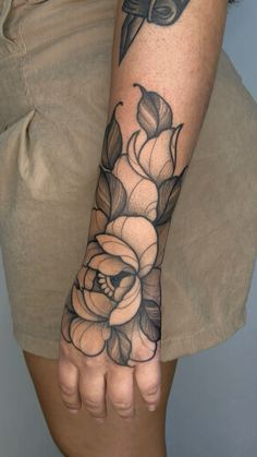 a woman's arm with flowers on it