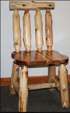 a wooden chair made out of logs on carpeted floor next to wall and door