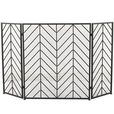 a black and white fireplace screen with an arrow pattern on the front, two sides