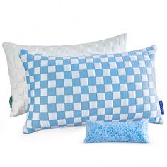 two blue and white checkered pillows sitting next to each other