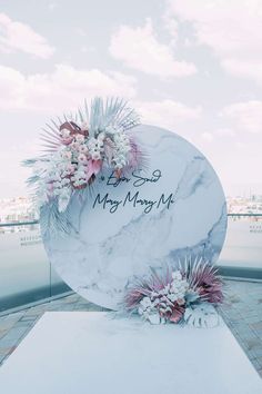 a white marble sign with flowers on it that says mr and mrs mary mj