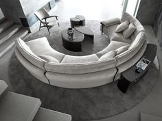 a circular couch sitting on top of a rug in a living room