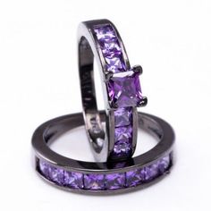 two wedding rings with purple stones on them