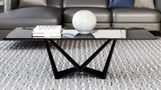 a black coffee table sitting on top of a carpeted floor next to a couch