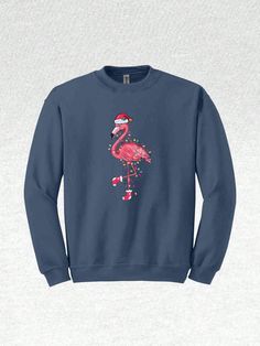 Get ready to flamingle into the festive spirit with our adorable Christmas Flamingo collection! This Cute Flamingo-themed attire is the perfect way to celebrate the season with a unique and tropical twist. Embrace the whimsical charm of Animal Christmas and light up your holiday gatherings with the radiant Flamingo Lights. Our Santa Beach Sweater embodies the perfect blend of Christmas cheer and beach vibes, ensuring you stand out in style. For those dreaming of a warm and tropical Christmas, our Tropical Christmas-themed Flamingo Santa attire is a must-have. This Pink Flamingo Hoodie adds a pop of color to your holiday wardrobe and keeps you cozy throughout the season. Whether you're planning a Christmas Vacation to a sunny destination or simply dreaming of one, our Happy New Year collect Flamingo Lights, Christmas Flamingo, Cute Flamingo, Florida Christmas, Beach Sweater, Beach Sweatshirt, Tropical Twist, Tropical Christmas, Flamingo Christmas