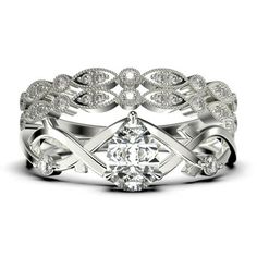 a white gold ring set with diamonds on the sides and an intricate design in the middle