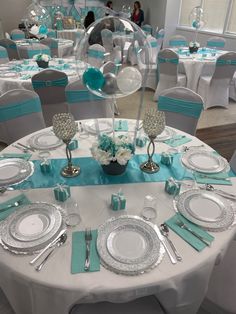 the tables are set with silver and blue decorations