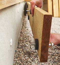 a person holding onto a piece of wood