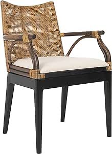 the arm chair is made out of rattan and has a white cushion on it