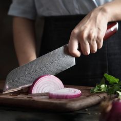 a person cutting onions with a large knife