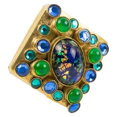 French jewelry designer Henry Perichon (also known as Henry) created this stunning gilt bronze pin brooch. The Medieval-inspired design is ornate with ovoid poured glass cabochons and crystal rhinestones in emerald green, turquoise green, and peacock blue colors. The pin is signed "Henry - Paris" on the underside and has a security closing clasp. Measurements: 1.25 in wide (3.2 cm) x 1.25 in deep (3.2 cm). Note: Henry Perichon (1910 - 1970), known as "Henry," is one of the most inventive jewelry Claudette Colbert, Vert Turquoise, French Jewelry, Pearl Brooch, Christian Lacroix, Peacock Blue, Jewelry Designer, White Metal, Pin Brooch