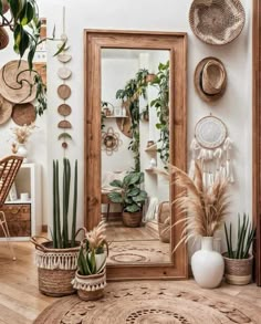 a mirror and some plants in a room