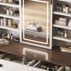 a mirror sitting on top of a wooden desk next to a shelf filled with books