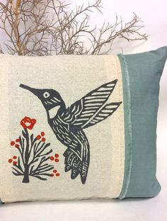 a decorative pillow with a bird on it