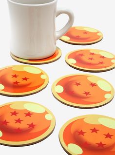 orange and yellow coasters with stars on them next to a white coffee cup in the middle