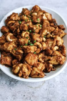 a white bowl filled with fried food on top of a table