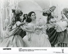 an old black and white photo of three women dressed in costume talking to each other