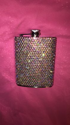 a flask shaped like a purse on a pink background