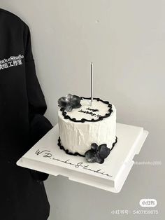 a person holding a cake with a knife in it