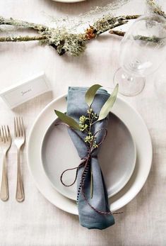 a place setting with silverware and napkins