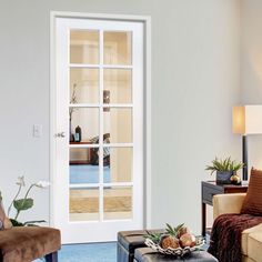 a living room filled with furniture and a white door