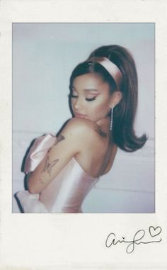 a woman with long hair wearing a pink dress