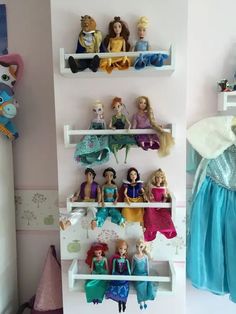 there are many princess dolls on the shelves