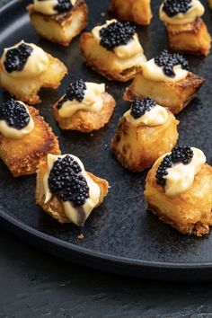 small pastries with blackberries and cream on a plate, ready to be eaten