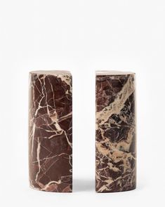 two marble vases sitting next to each other