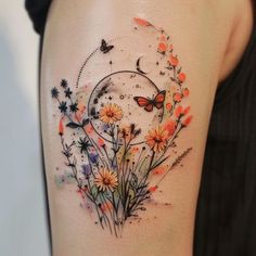 a woman's thigh with flowers and butterflies on her left side, while the lower half is covered in watercolor