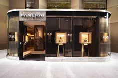 an entrance to a building with two gold pedestals in front of it and the words panera written on the door