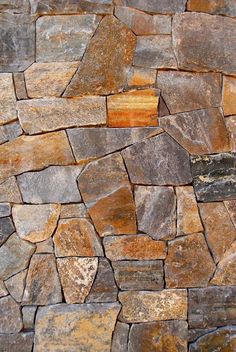 a stone wall made up of many different colored stones