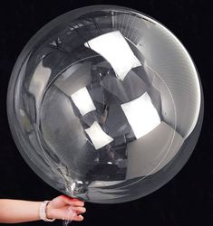 a person holding a large clear object in their hand