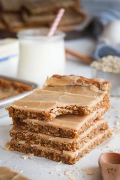 three pieces of cake sitting on top of a white plate next to a glass of milk