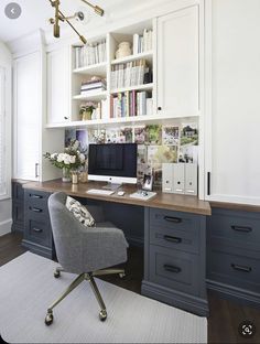 a home office with white cabinets and blue drawers