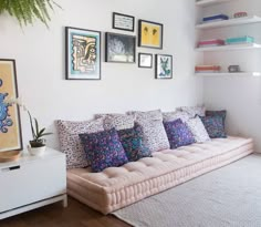 a living room filled with lots of furniture and pictures on the wall above it's couch