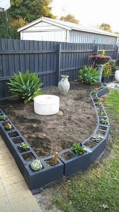 an image of a garden in the middle of a yard with plants growing out of it