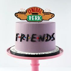 a pink cake with the words friends on it and a central perk sign above top