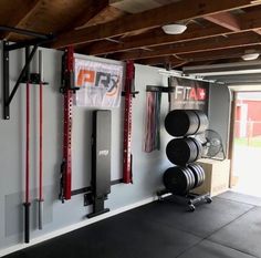 a garage with gym equipment hanging on the wall