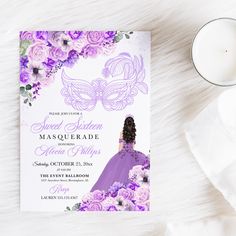 a purple masquerade themed wedding card with flowers and a candle on a white furnishing