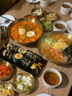 a table topped with lots of different types of food and bowls on top of it