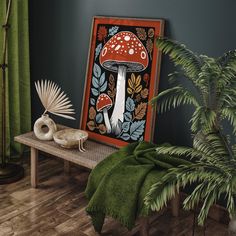 a painting on a table next to a plant and other items in front of it