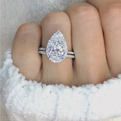 a woman's hand with a diamond ring on it