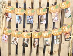 a wooden pallet with pumpkins and pictures hanging from it's sides, on which are numbered numbers