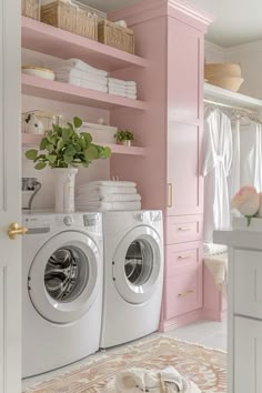 a washer and dryer in a small room with pink shelving behind it